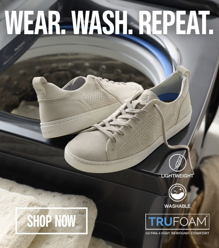 A banner image that is split into three sections. The first section shows a pair of white casual sneakers sitting on a washing machine. The middle section has the words Wear. Wash. Repeat. with a Shop Now button at the bottom. And the right section of the image shows the white casual sneakers going into the washing machine. 